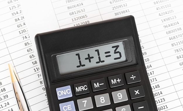 Premium Photo | Calculator with the word 1 plus 1 equally 3 on the display.